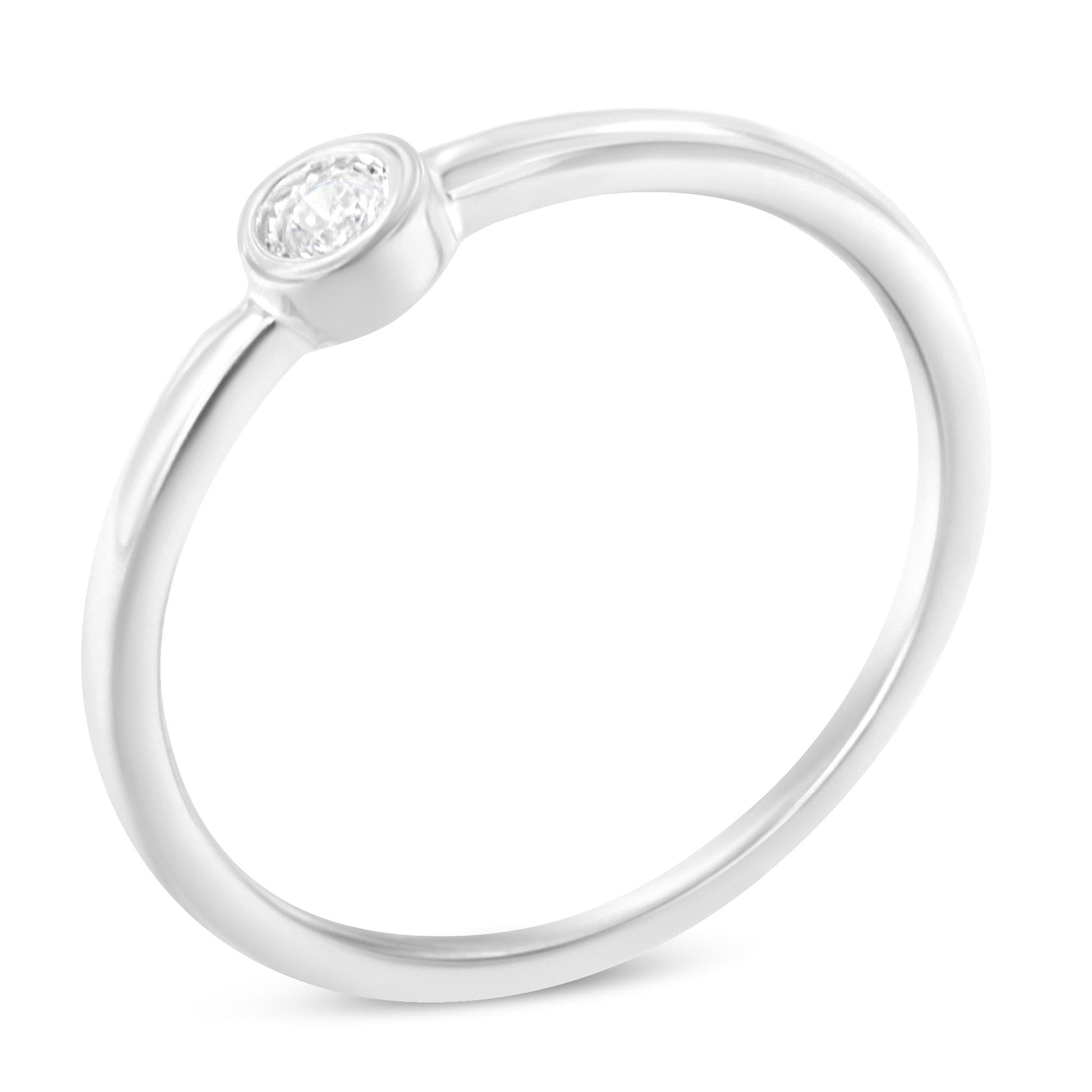 White metal ring with a round white gemstone in a miracle setting, shown at a slight angled top-down view.