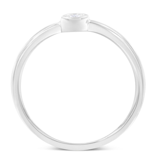 Top-down view of a white metal ring featuring a single round white gemstone in a miracle setting.