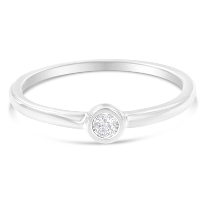 Front angle of a white metal ring with a single round white gemstone in a miracle setting.