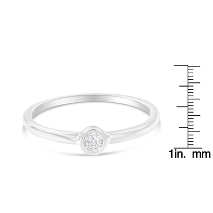 White metal ring with a round white gemstone in a miracle setting, shown in a front angle with a ruler for size reference.
