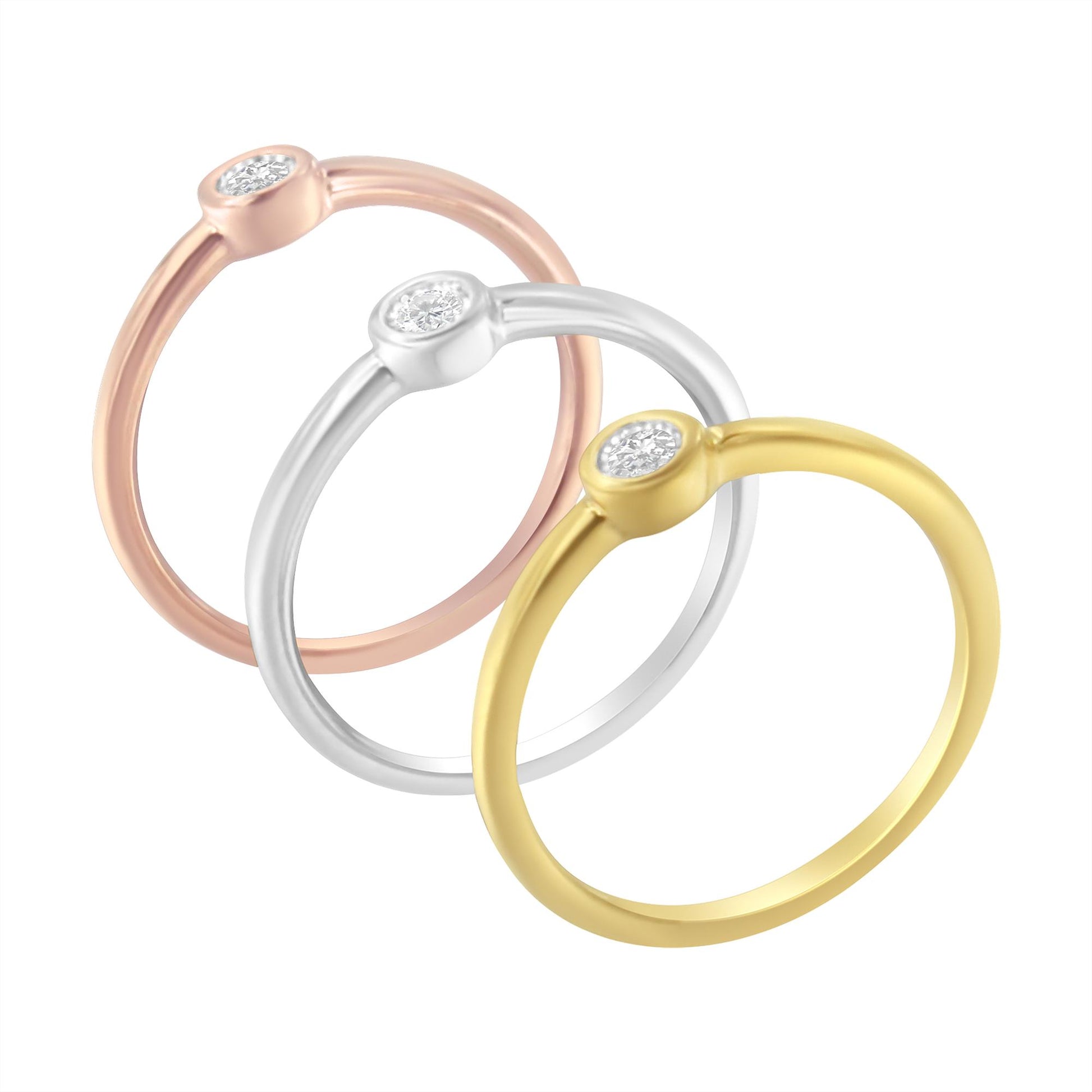 Three rings in yellow, white, and rose metal colors with a round white gemstone in miracle setting, shown in a front angled view.