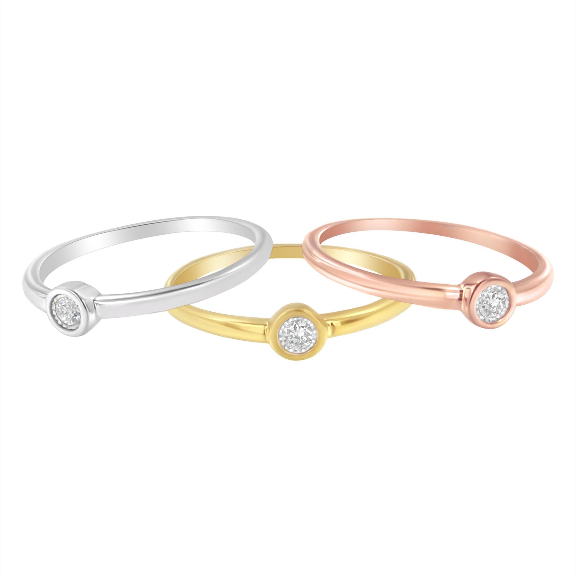 Three rings in yellow, white, and rose metal colors, each with a round white gemstone set in a miracle setting, shot from an angled front view.