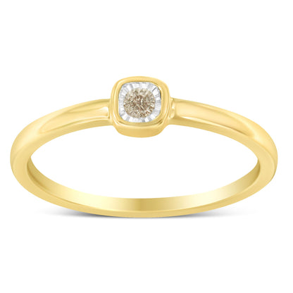 Front view of a yellow ring with a round white gemstone in a miracle setting.