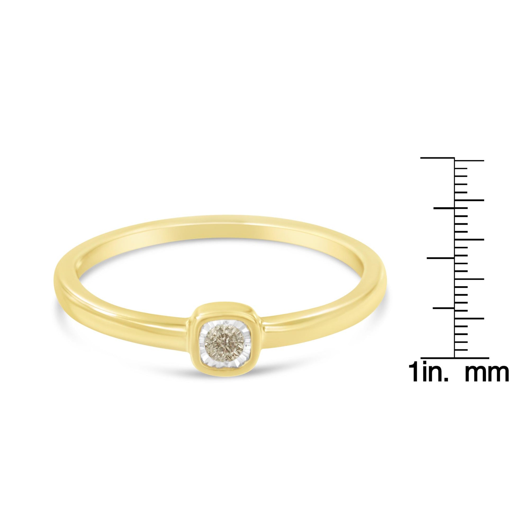 Yellow metal ring with a round white gemstone in a miracle setting, front angle view, shown on a ruler for size reference.