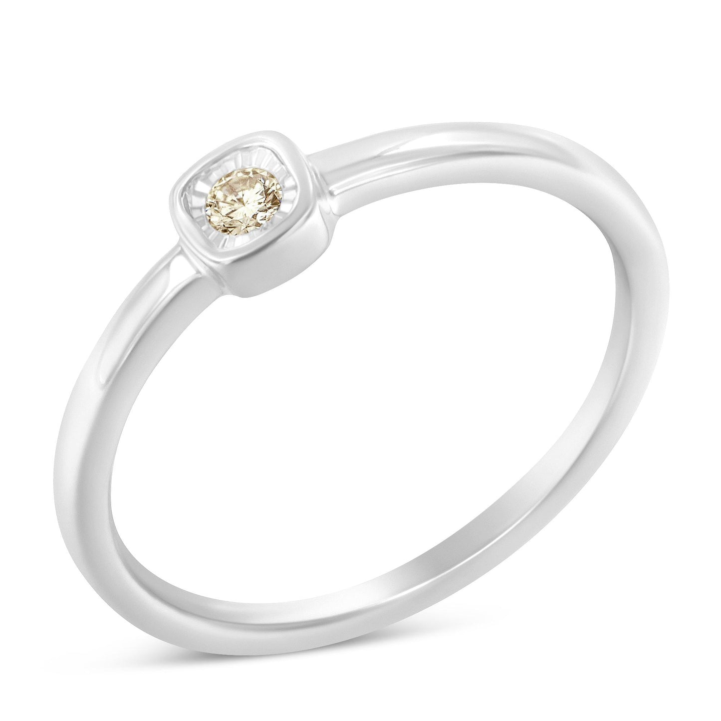 White metal ring with a round white gemstone in a miracle setting, shown in a close-up angled view.