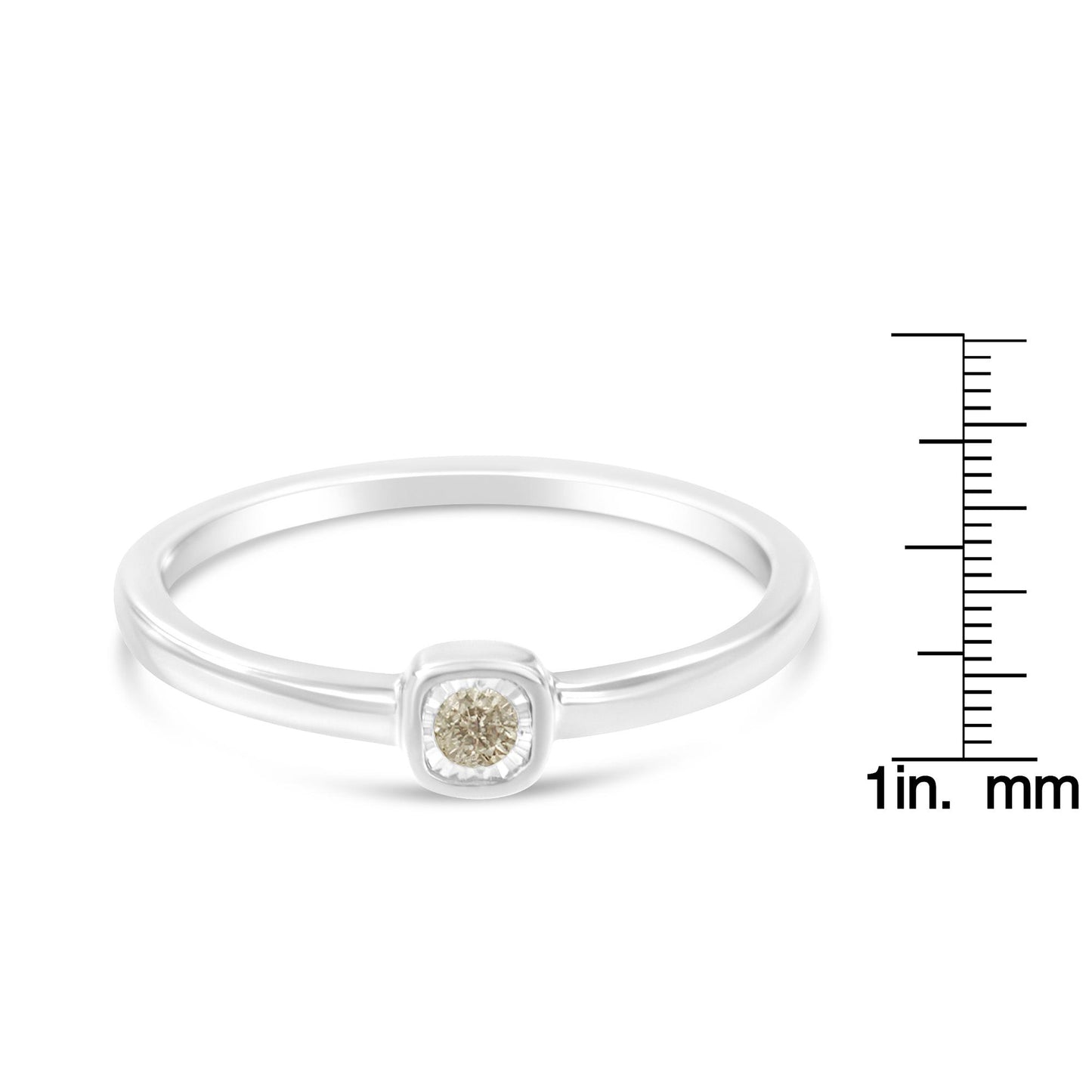 White metal ring with a single round white gemstone in miracle setting, shown from front angle, on a ruler for size reference.