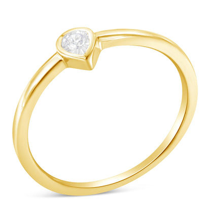Close-up angled view of a yellow metal ring featuring a single round white gemstone in a miracle setting.
