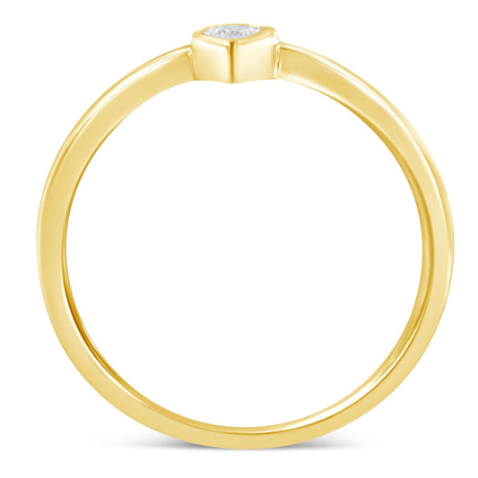Top-down angled view of a yellow metal ring with a single round white gemstone in a miracle setting.