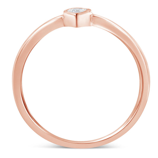 Close-up front view of a rose-colored ring featuring a single round white gemstone set in a miracle setting.