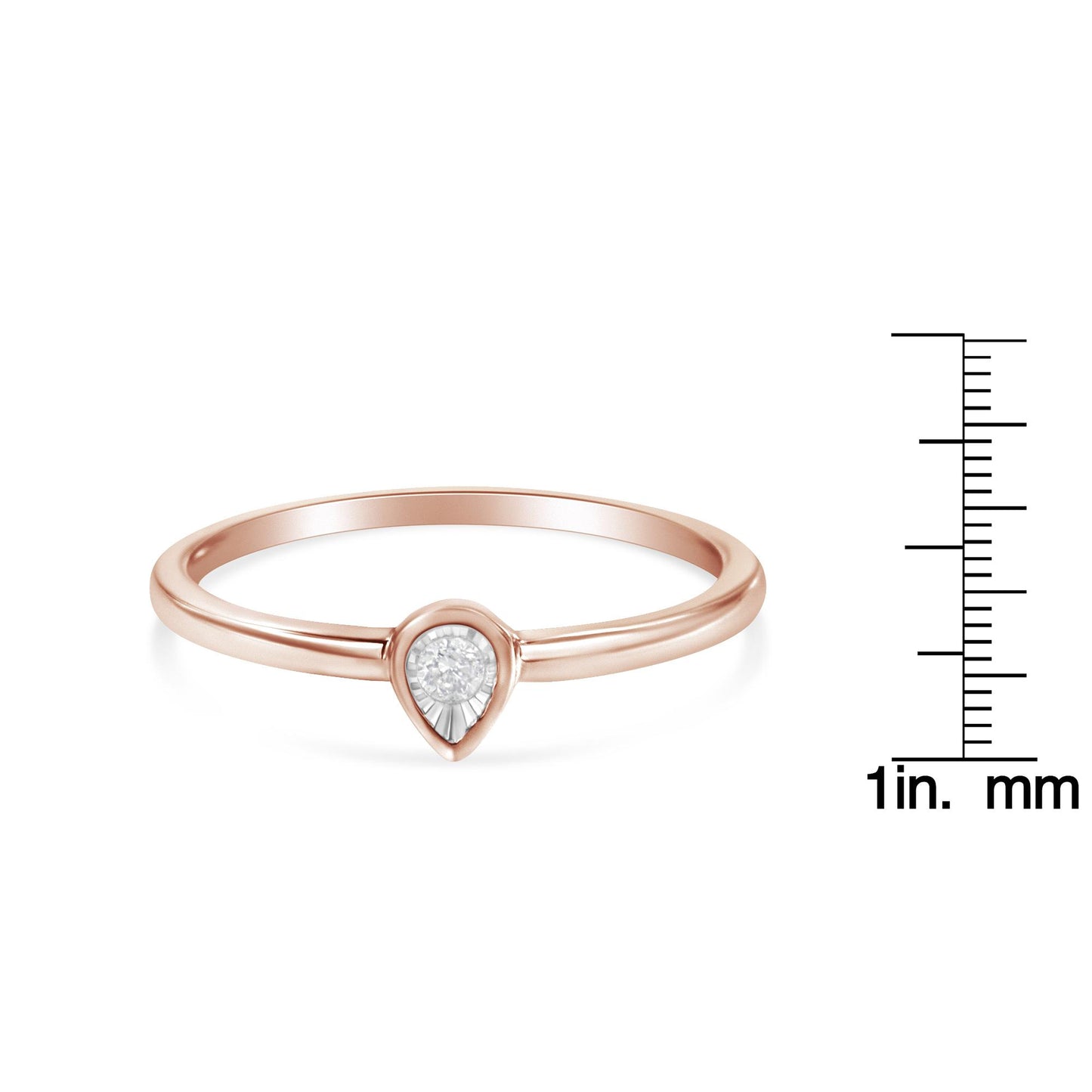 Close-up of a rose-colored ring with a single white round gemstone in a miracle setting, shown from a slight angle with a ruler for size reference.