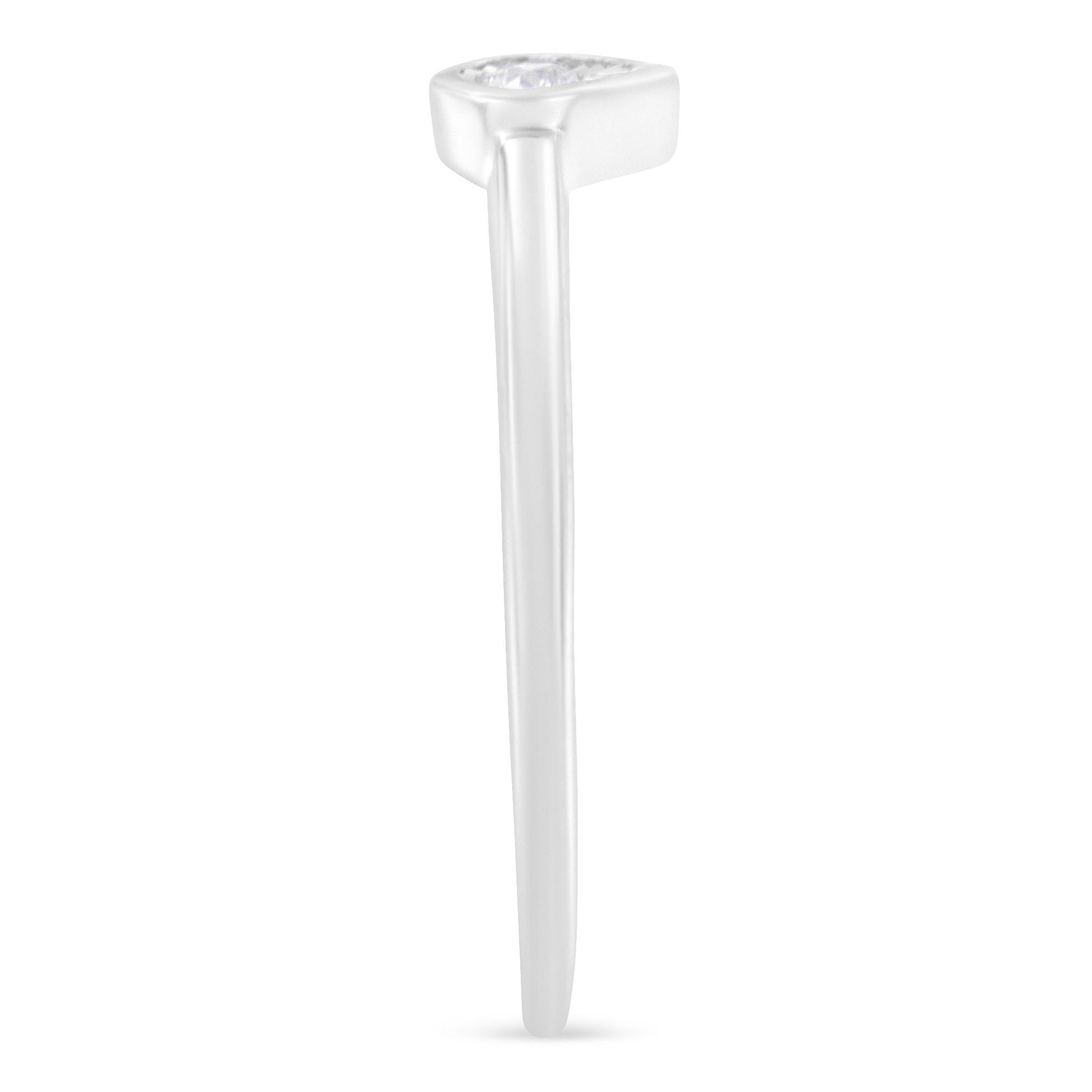 White metal ring with a single round white gemstone in a miracle setting, shown from the side angle.