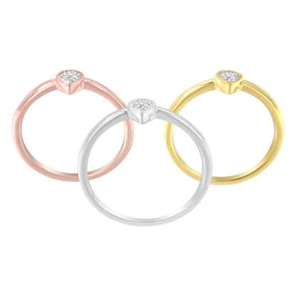 Three rings in yellow, white, and rose metal colors, each with a round white gemstone in a miracle setting, shown from a slightly elevated frontal angle.