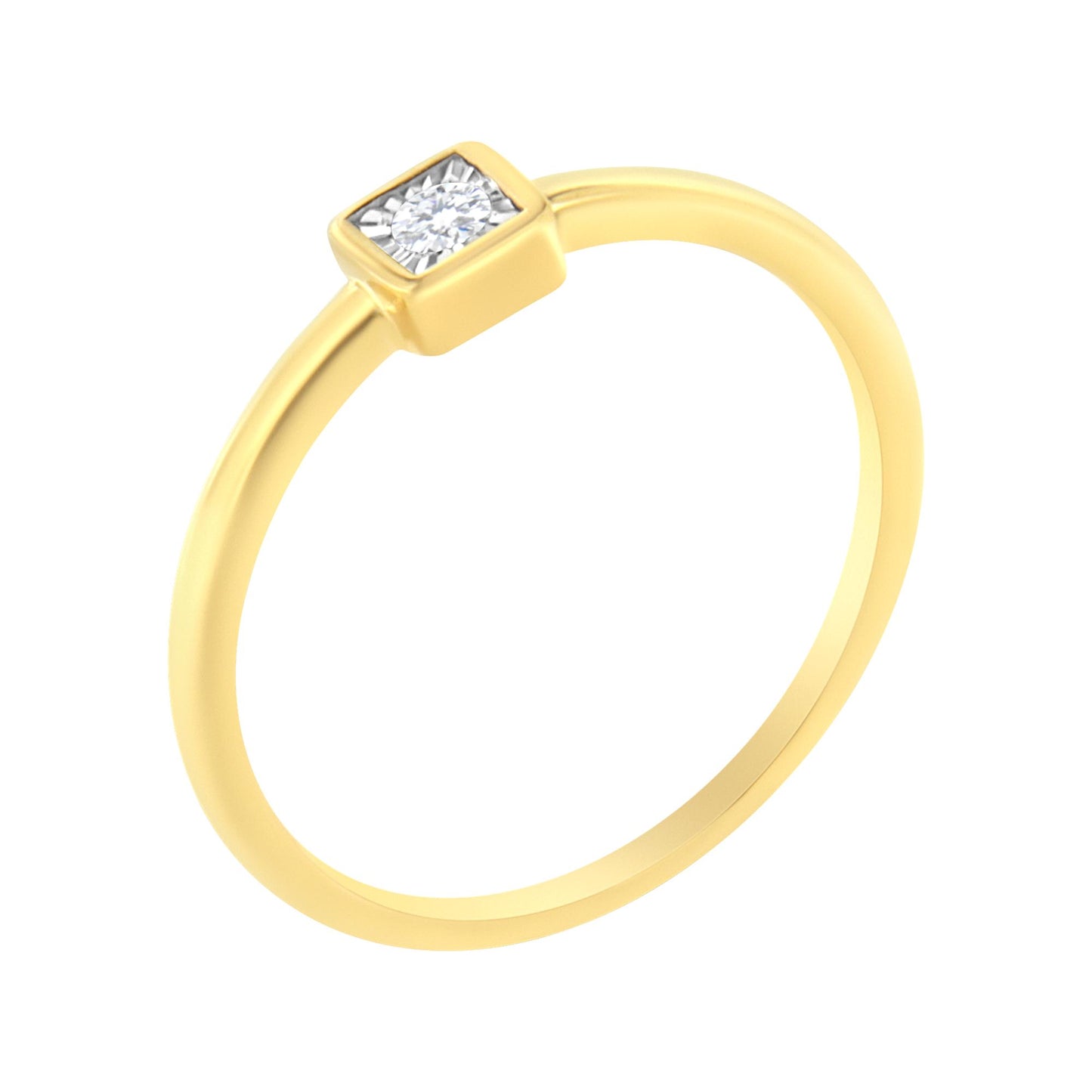 Yellow metal ring with a single round white gemstone in a square setting, shown at an angled top view.