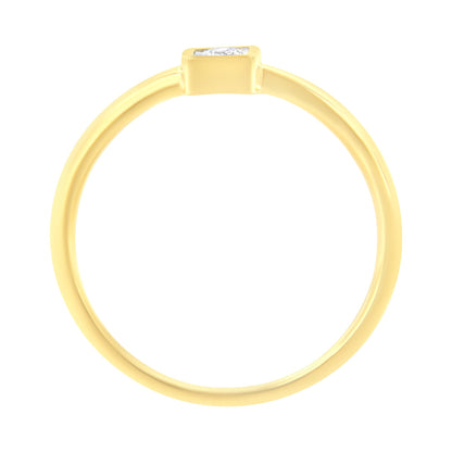 Top view of a yellow metal ring with a single round white gemstone set in a miracle setting.