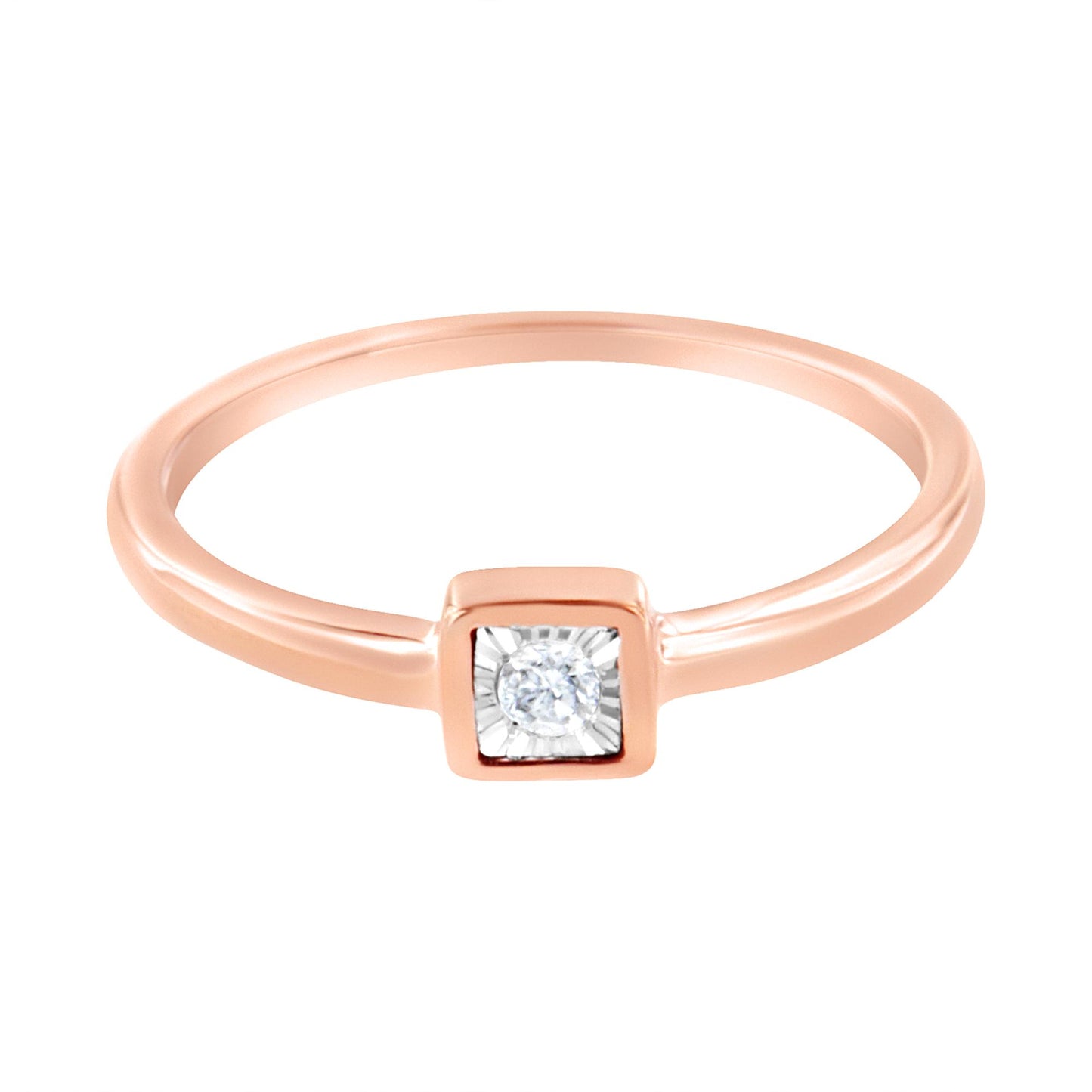 Rose metal ring with a round white gemstone in a square bezel setting, top-down angle.