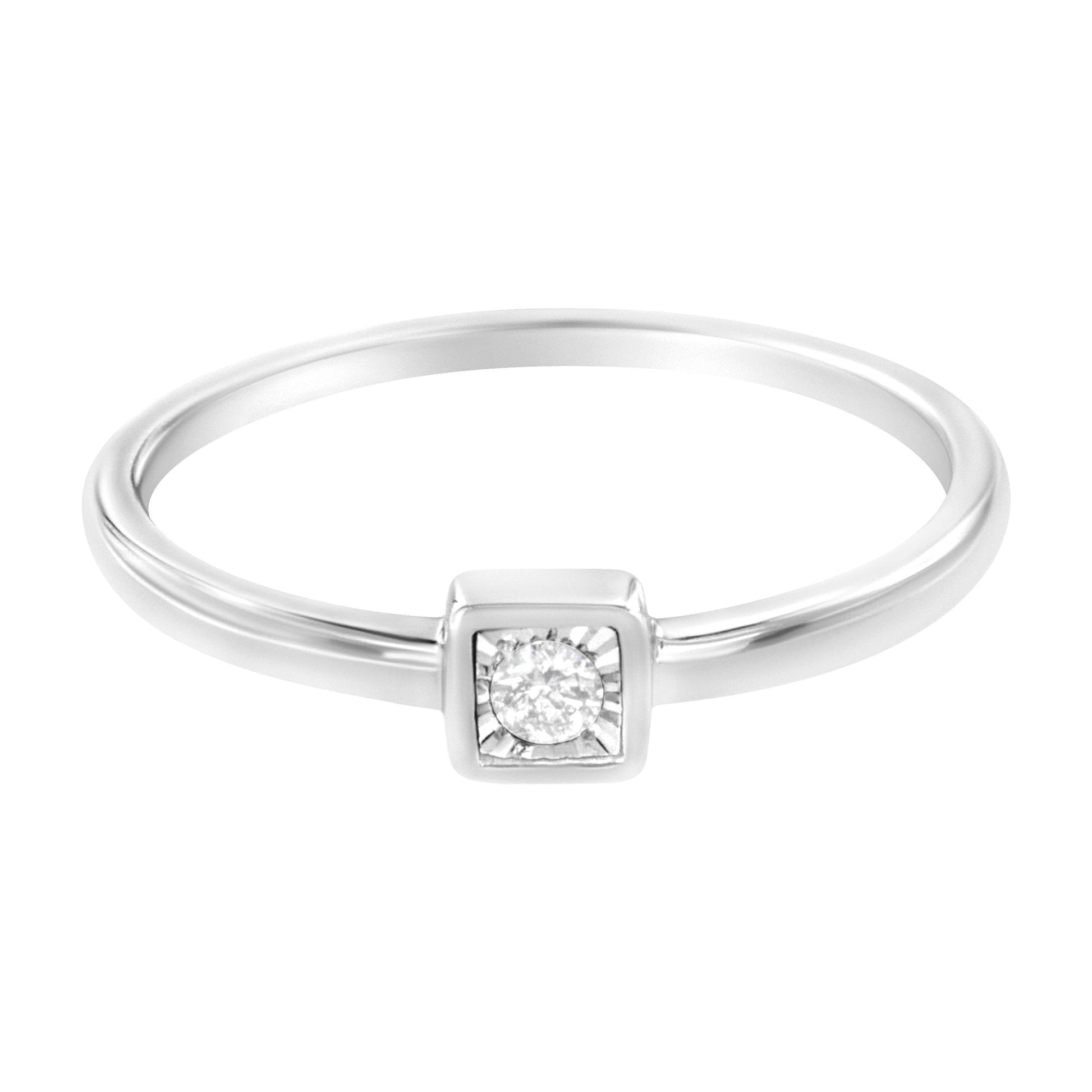 Front view of a white metal ring with a round white gemstone in a square setting.