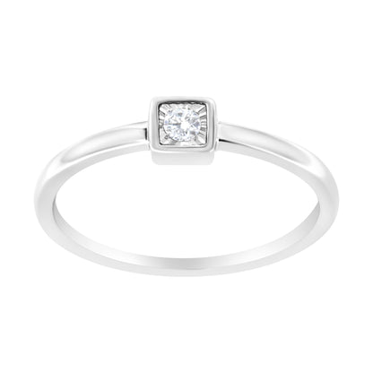 Front-facing white metal ring with a round white gemstone in a square bezel setting.