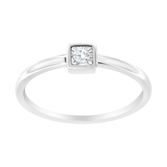 Front-facing white metal ring with a round white gemstone in a square bezel setting.