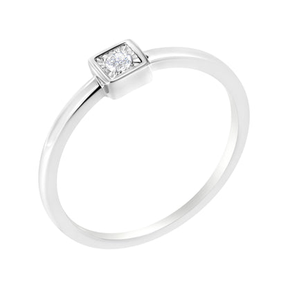 White metal ring with a single round white gemstone in a raised square setting, shown at an angled top-down view.