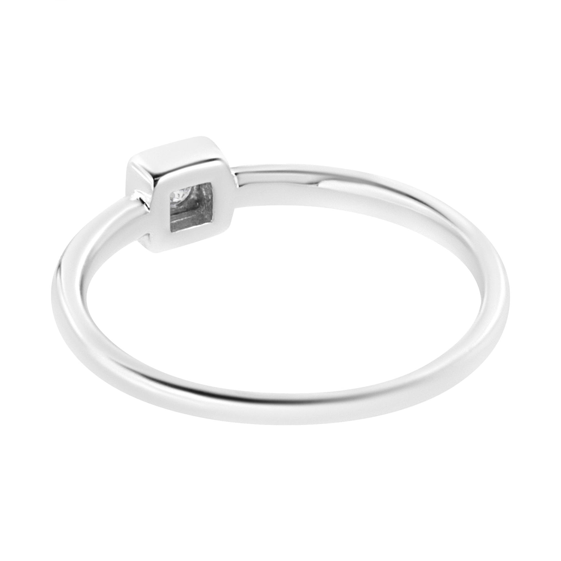 White metal ring with a single round white gemstone in a square miracle setting, shown at a slight angle.