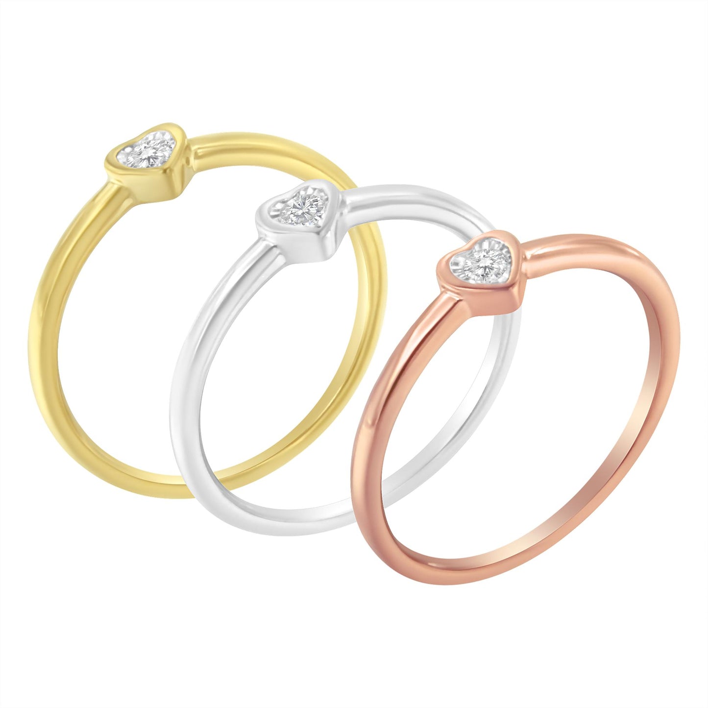 Three rings in yellow, white, and rose metal colors with heart-shaped settings each featuring a round white gemstone, shown from a front angle.