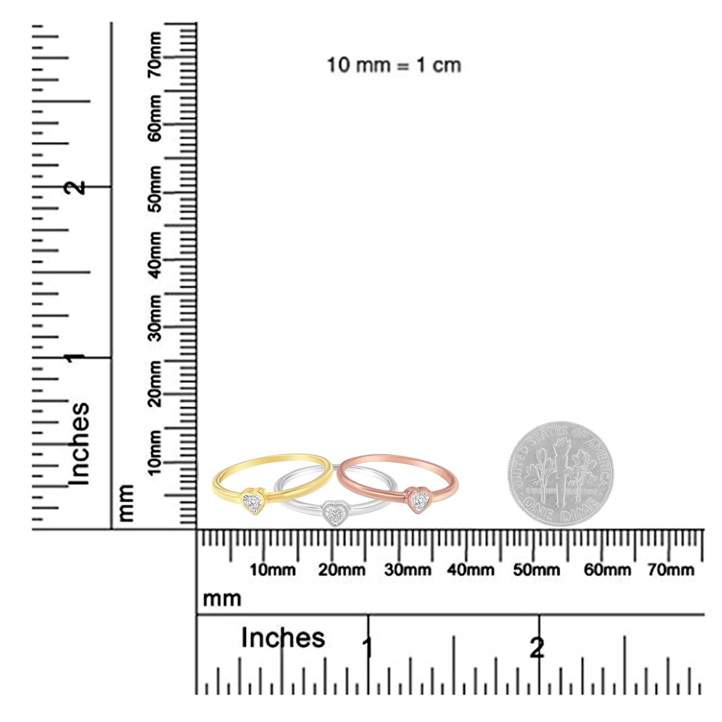 Three rings in yellow, white, and rose metal colors with heart-shaped settings featuring round white gemstones, displayed on a ruler and scale for size reference, front view.