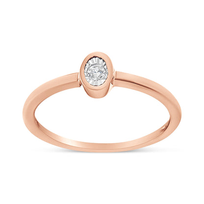 Front angle view of a rose-colored ring featuring a single round white gemstone in a miracle setting.
