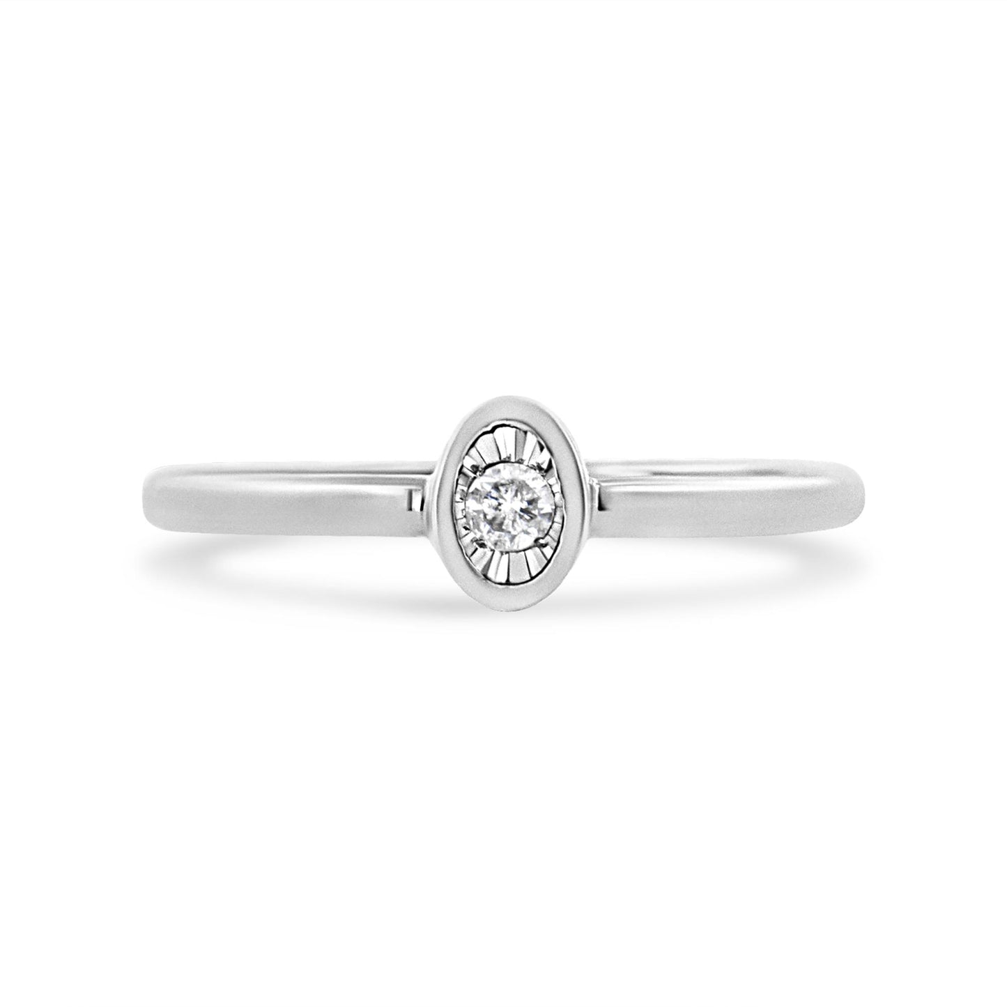 Front-facing shot of a white metal ring with a round white gemstone in a miracle setting.