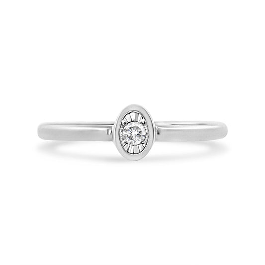 Front-facing shot of a white metal ring with a round white gemstone in a miracle setting.