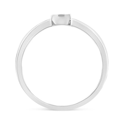 Front profile of a white metal ring featuring a single round white gemstone in a miracle setting.