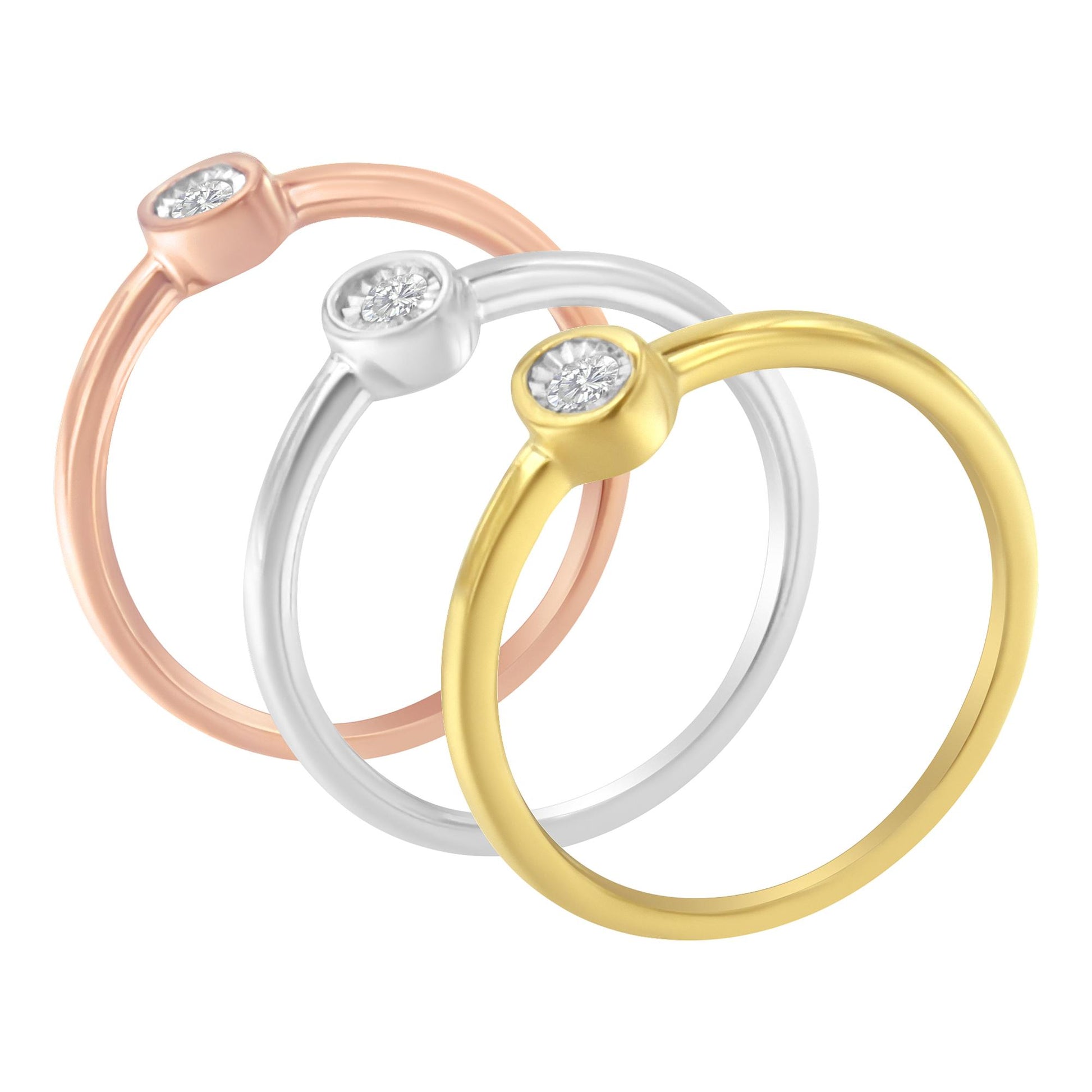Three rings with yellow, white, and rose metal colors, each featuring a round white gemstone in a bezel setting, shown in a slight top-down angle.