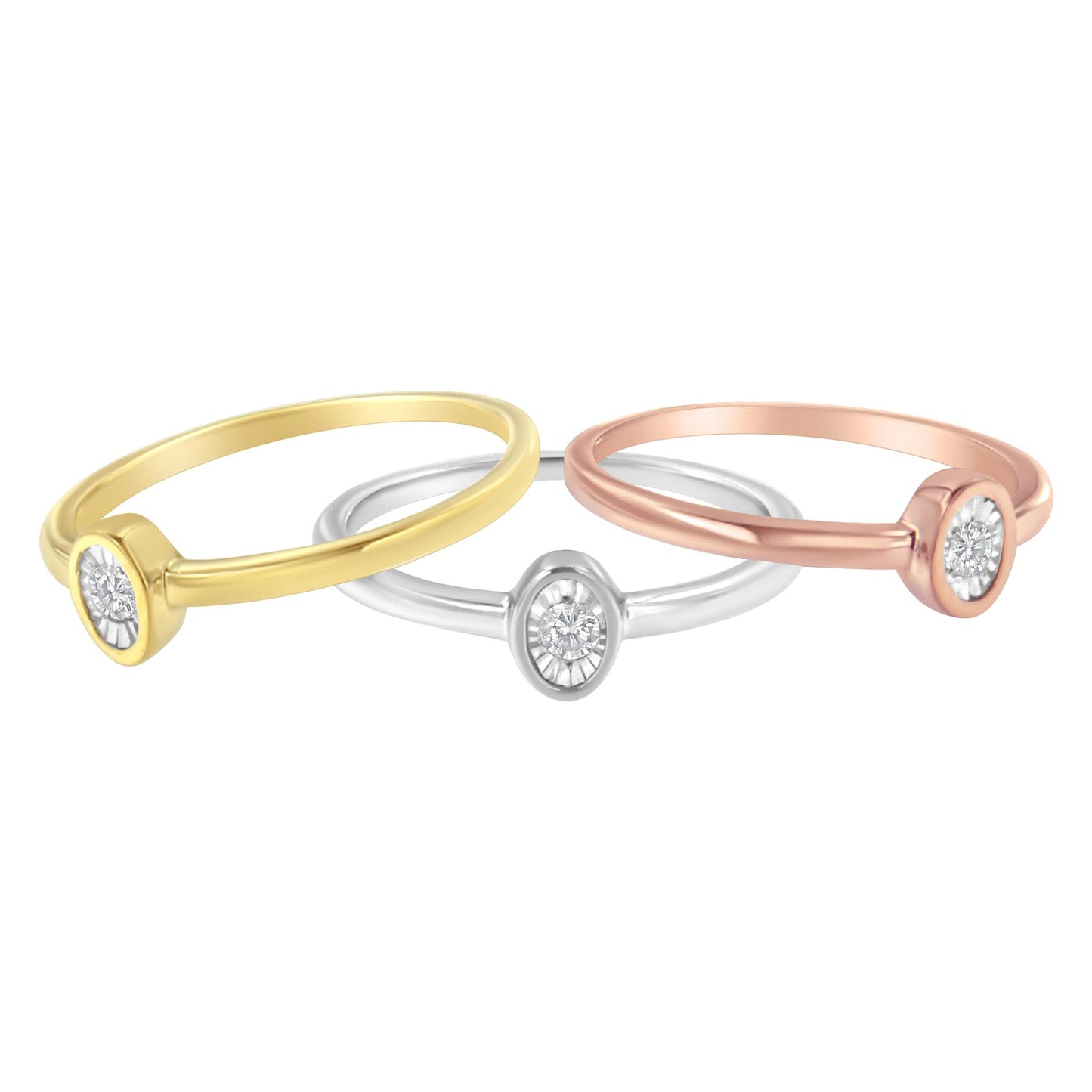 Three rings in yellow, white, and rose metal colors shown from a front angled view, each with a round white gemstone in a miracle setting.