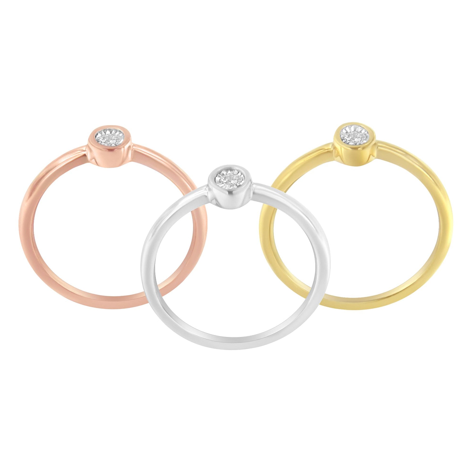 Front-facing view of three rings in yellow, white, and rose metal colors, each featuring a round white gemstone in miracle setting.