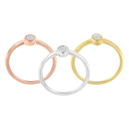 Front-facing view of three rings in yellow, white, and rose metal colors, each featuring a round white gemstone in miracle setting.