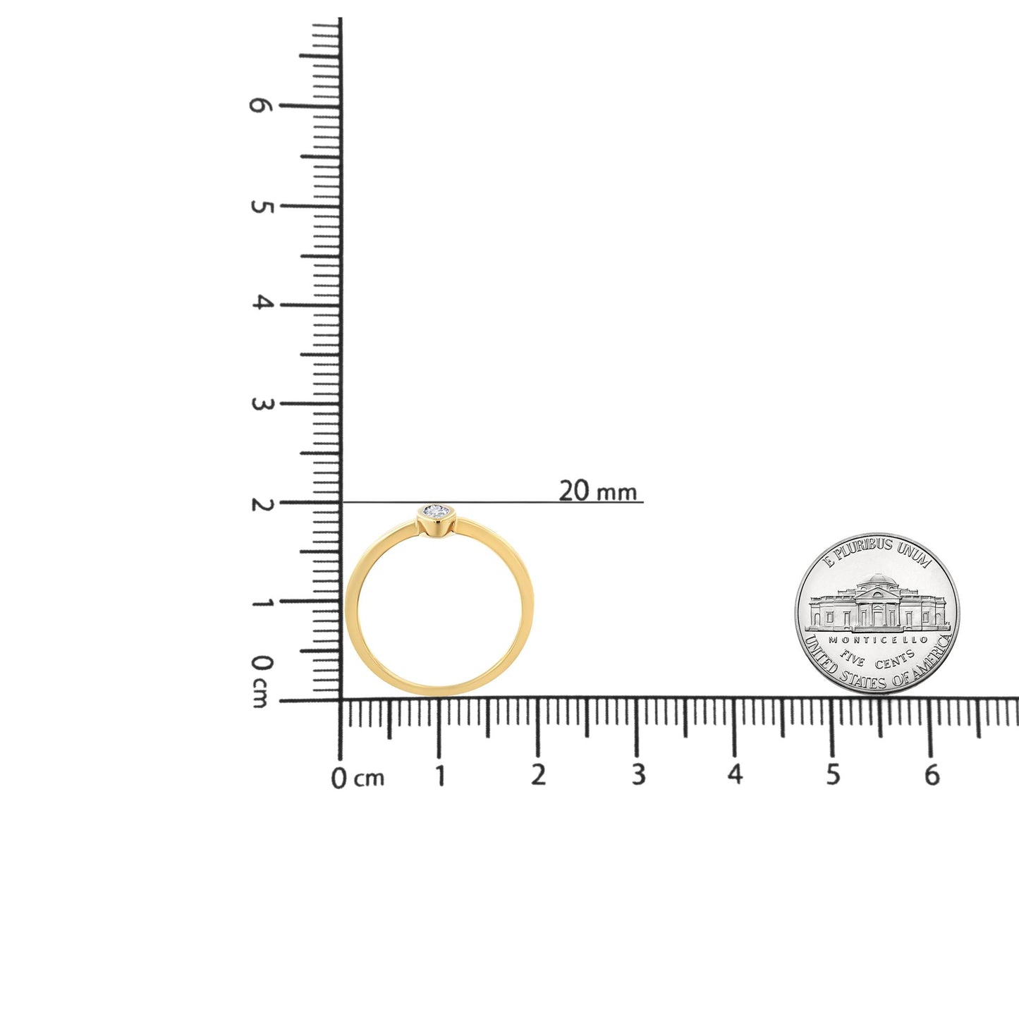 Top view of a yellow ring with a single white round gemstone in miracle setting, placed on a ruler for size reference.