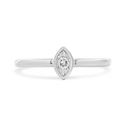 Front view of a white metal ring with a marquise-shaped setting featuring a round white gemstone in the center.