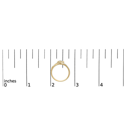 Yellow metal ring with multiple white round gemstones in pave setting, side view, shown on a measurement scale.