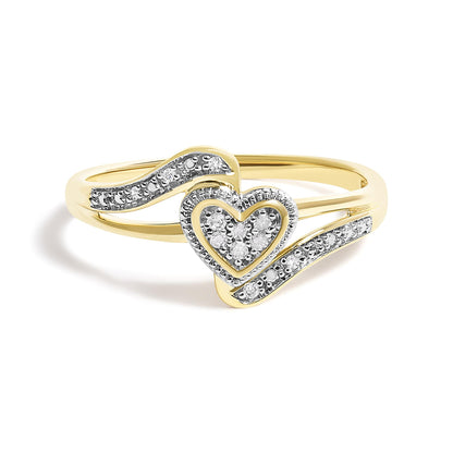 Yellow metal ring with a heart shape at the center adorned with round white gemstones in pave settings, flanked by curved bands also set with round white gemstones, shown from a front angle.