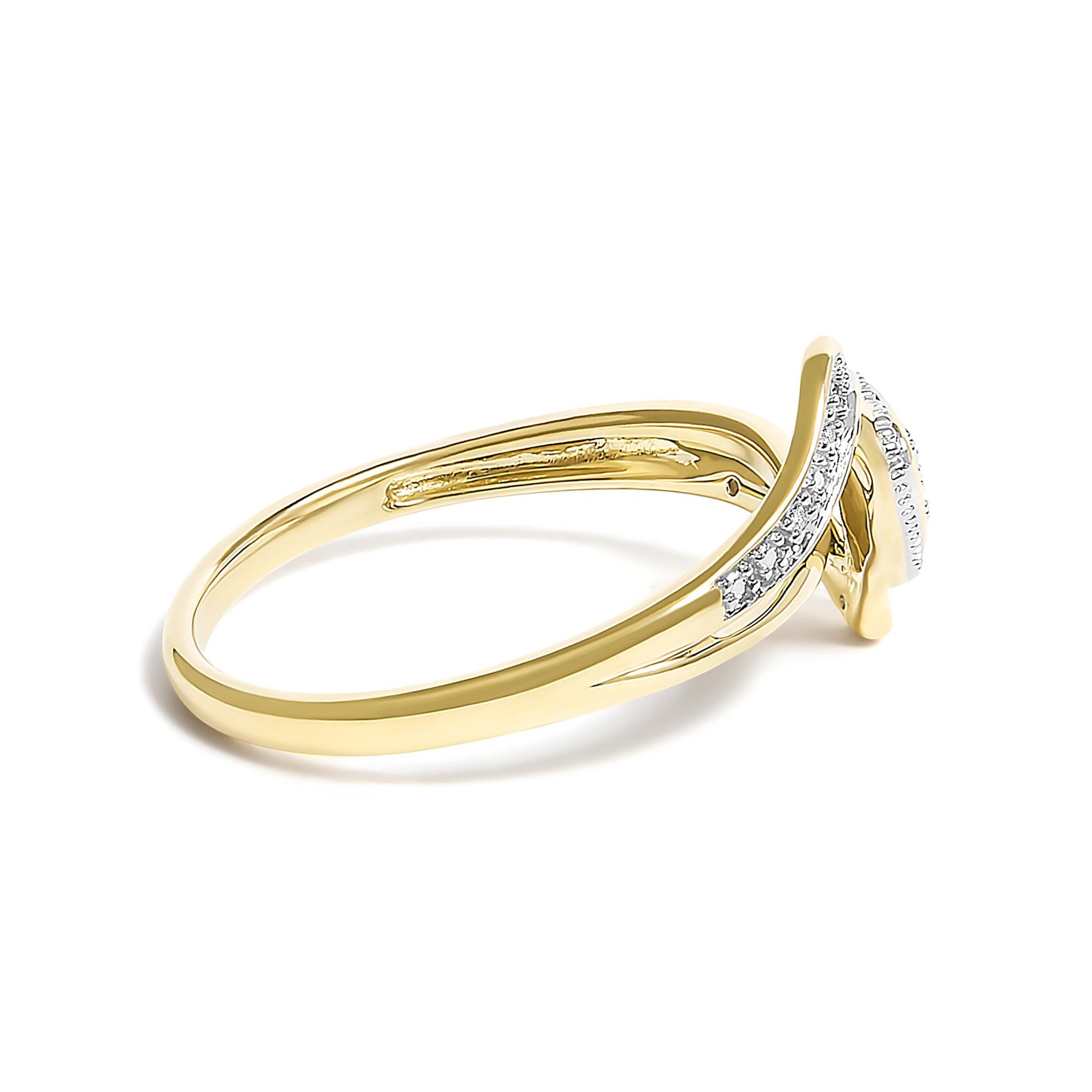 Yellow metal ring with a curved design, featuring white round pave-set gemstones, shown in a close-up angled side view.