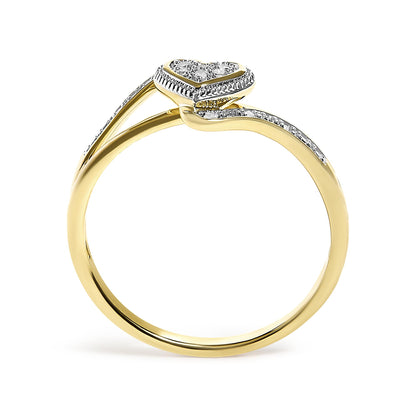 Yellow metal ring with a split shank design, featuring a heart-shaped cluster of white gemstones in pave settings, shown in a side view on a white background.