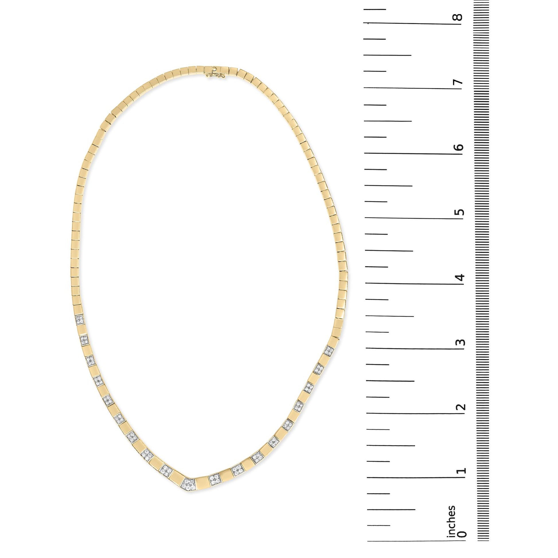 Top-down view of a yellow metal necklace with evenly spaced white round gemstones in 4-prong settings, displayed next to a ruler for size reference.