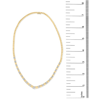 Top-down view of a yellow metal necklace with evenly spaced white round gemstones in 4-prong settings, displayed next to a ruler for size reference.