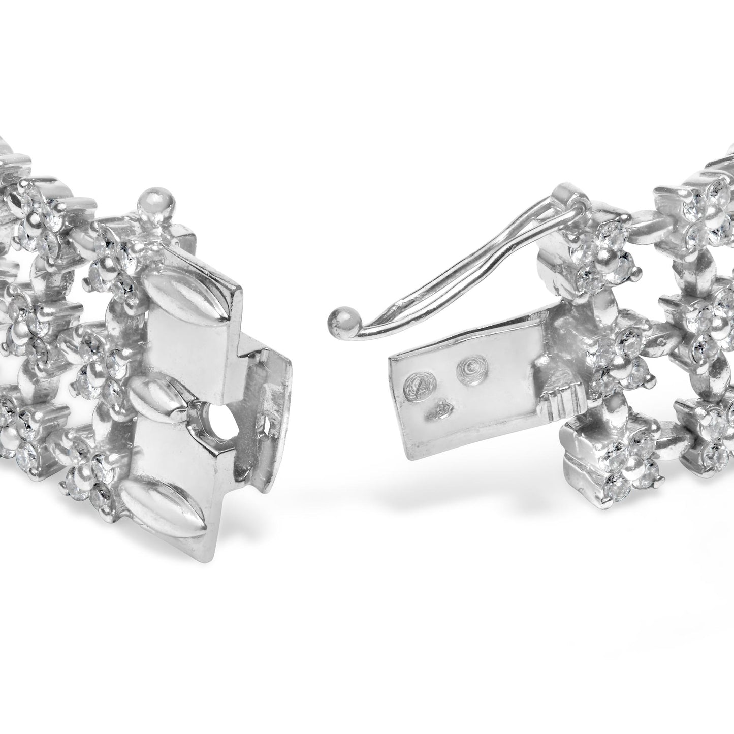 Close-up front angle of a white metal bracelet with round white gemstones in 4-prong settings, showing the clasp open.