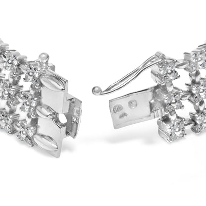 Close-up front angle of a white metal bracelet with round white gemstones in 4-prong settings, showing the clasp open.