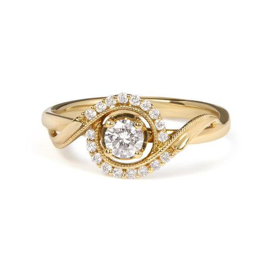 Yellow metal ring with a round white gemstone in a four-prong setting at center, surrounded by a swirl of smaller round white gemstones in shared prong settings, front angle view.