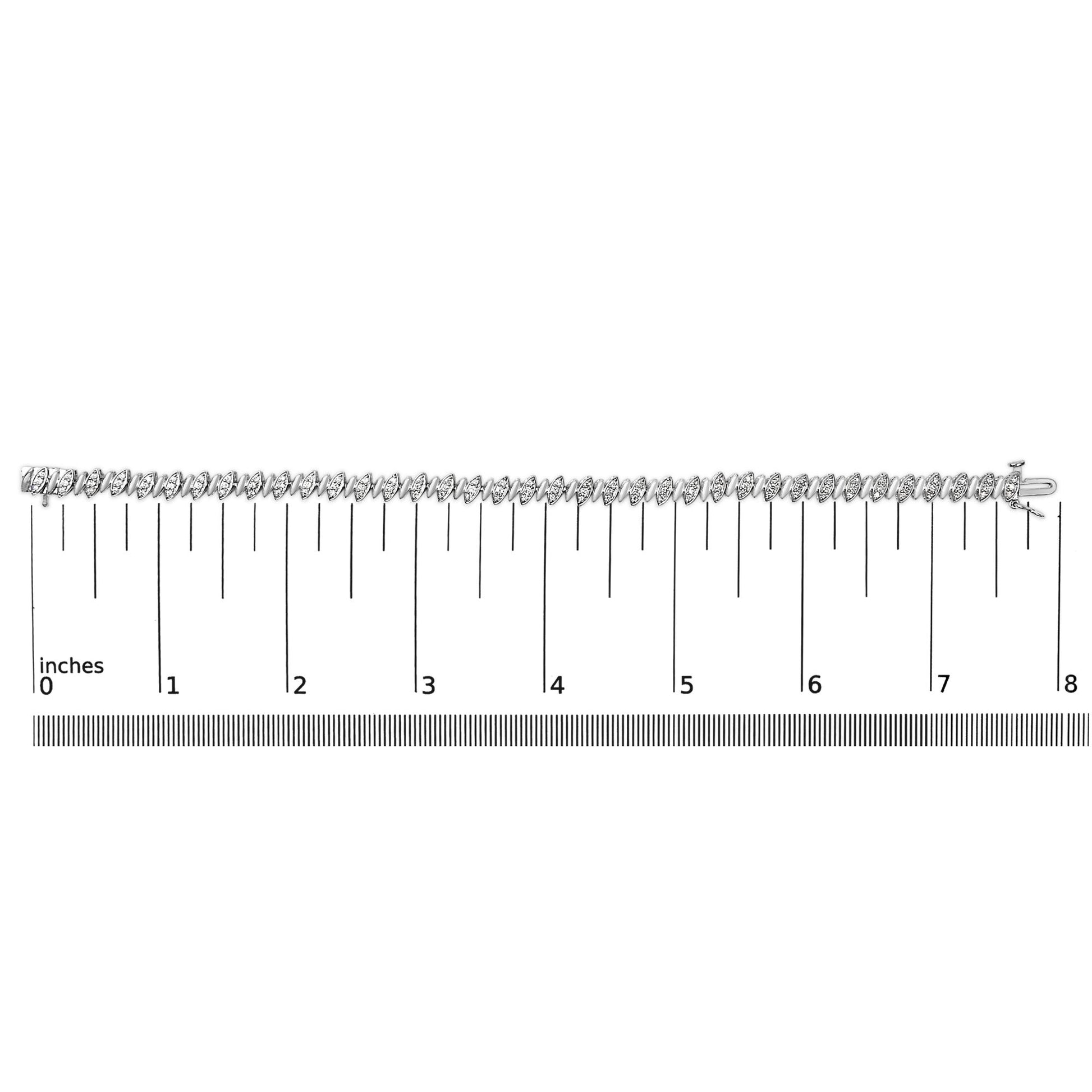 White metal bracelet with round white gemstones in pave setting, shown horizontally on a ruler scale, angled from above.