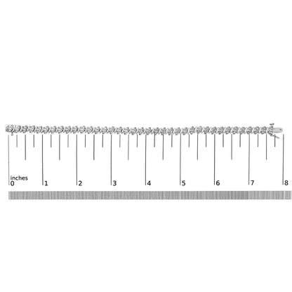 White metal bracelet with round white gemstones in pave setting, shown horizontally on a ruler scale, angled from above.