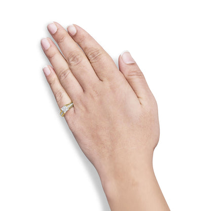 Yellow metal ring with white princess-shaped gemstones, invisible and channel settings, worn on a model's hand, shown from above.
