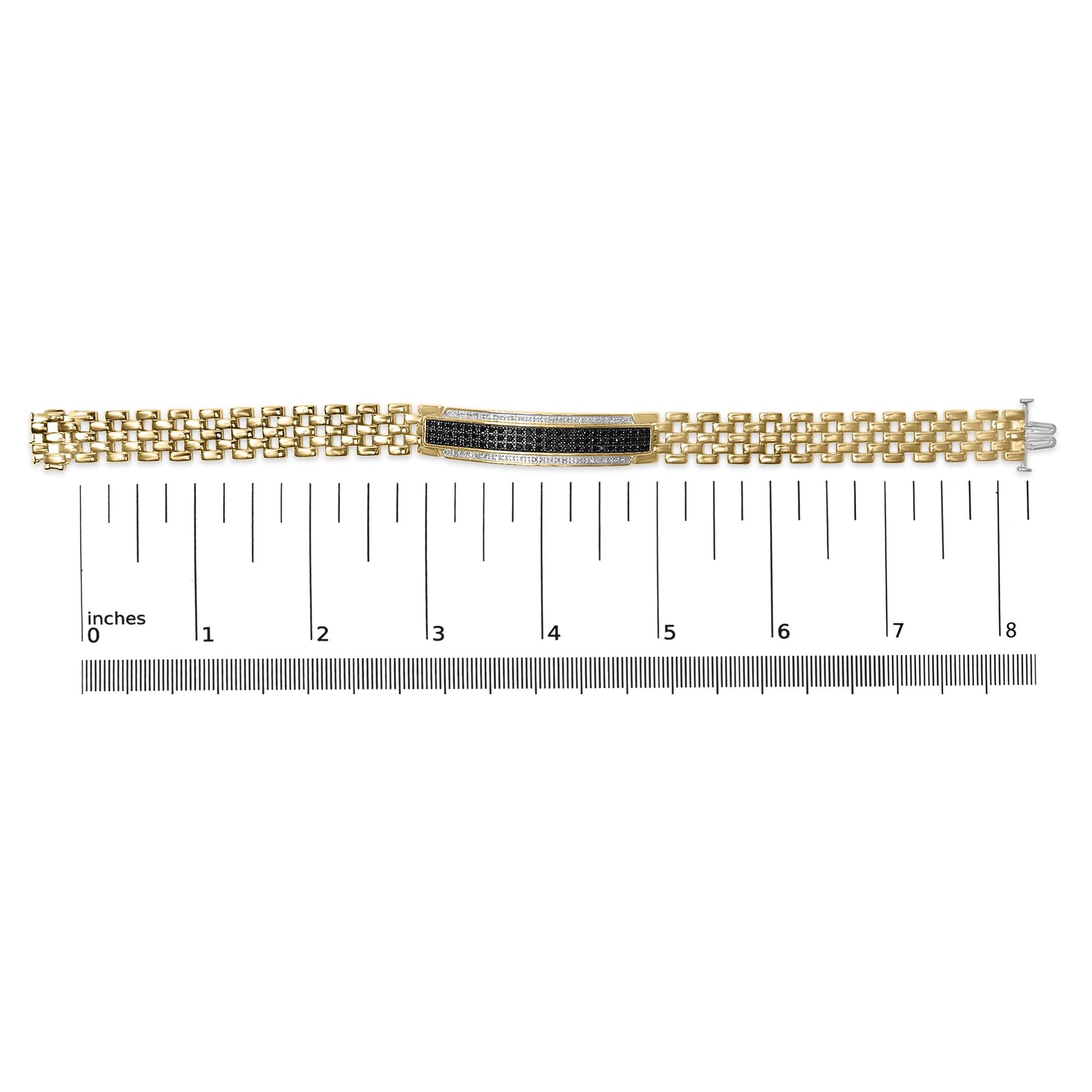 Yellow metal bracelet with a rectangular center piece featuring pave-set round black and white gemstones, shown on a scale, top-down view.
