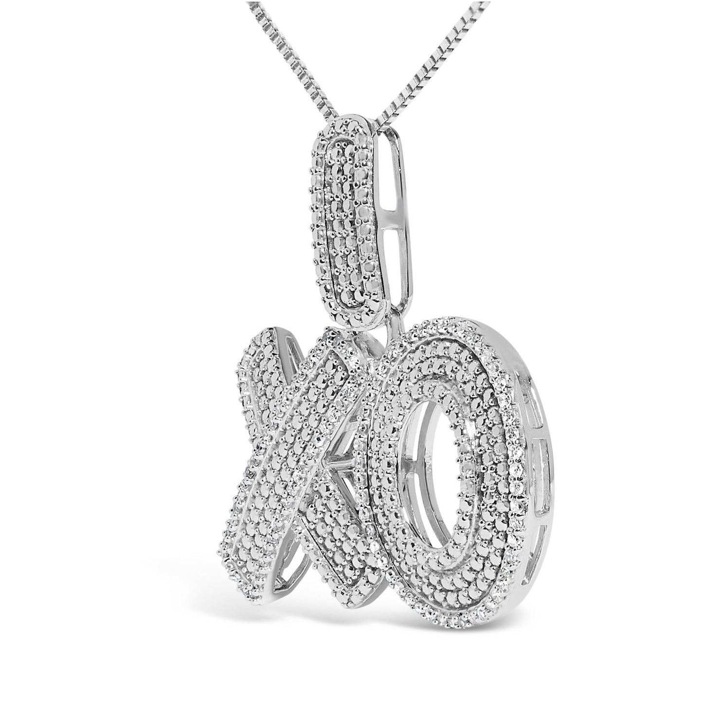 Close-up front angled shot of a white metal necklace pendant in an 'XO' design, encrusted with multiple small round white gemstones in prong settings.